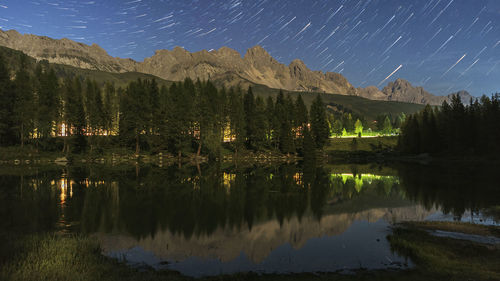 Scenic view of lake against sky at night