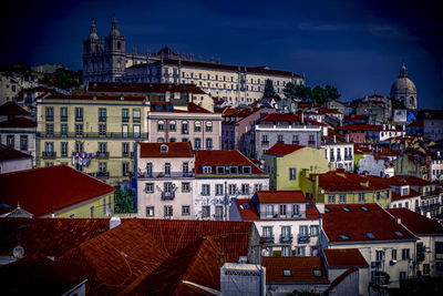 Houses in town against sky in city