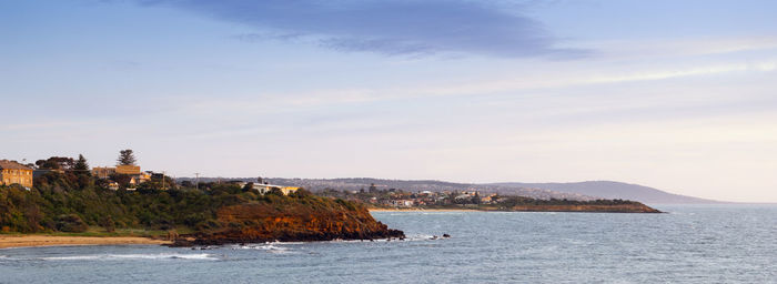 Scenic view of sea and buildings against sky