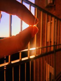 Close-up of hand holding railing