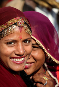 Close-up portrait of smiling young woman