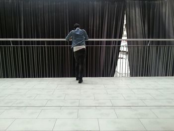 Rear view of man on railing