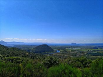 Scenic view of landscape against blue sky