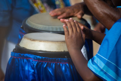 Percussionist hands playing atabaque.