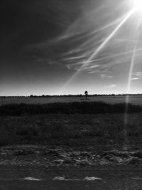 Silhouette man standing on field against sky