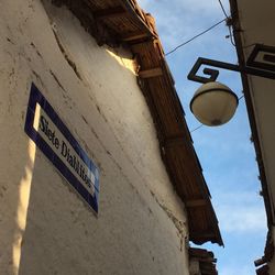 Low angle view of road sign against sky