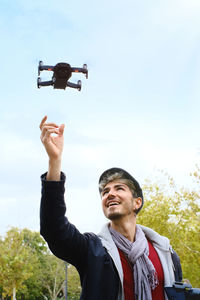 Full length portrait of young man photographing