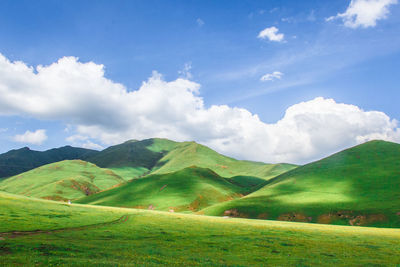 Scenic view of mountains against cloudy sky