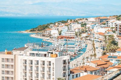 High angle view of buildings by sea against sky