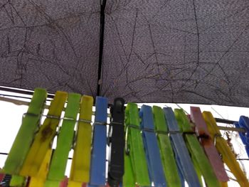 Low angle view of clothespins hanging on clothesline