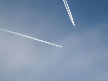 Low angle view of airplane flying against clear sky