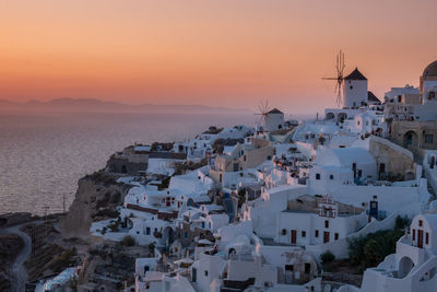 Panoramic view of buildings and sea against sky during sunset