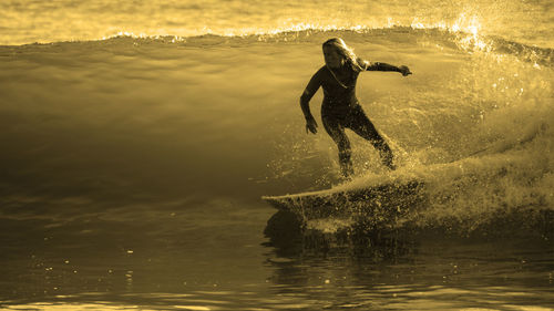 Surfer girl riding an ocean  wave.