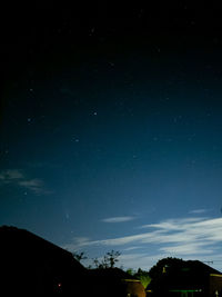 Low angle view of silhouette trees against sky at night