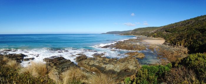 Scenic view of sea against clear blue sky