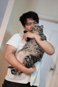Young woman with cat at home