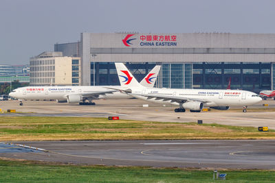 Airplane on runway against sky