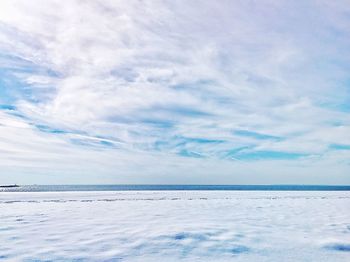 Scenic view of sea against cloudy sky