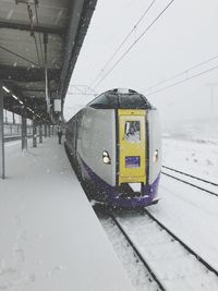 Train on railroad tracks during winter