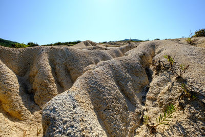 Rock formations on landscape against clear sky