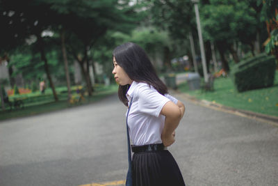 Woman in uniform standing on road