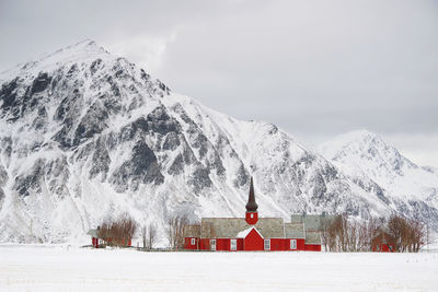 Built structure on snowcapped mountain against sky