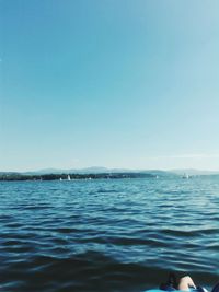 Scenic view of sea against clear blue sky