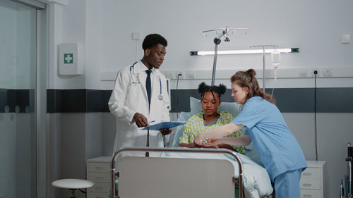 Female doctor examining patient in hospital