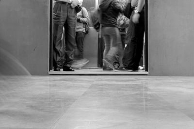 Low section of people standing in elevator