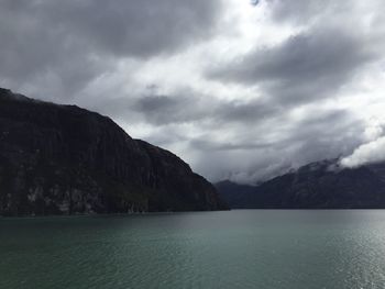 Scenic view of mountains against cloudy sky