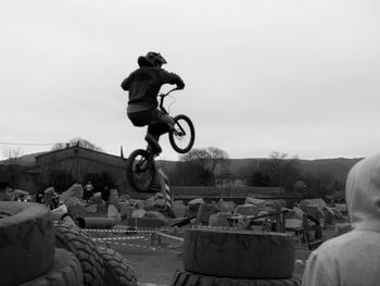 Man riding motorcycle against sky