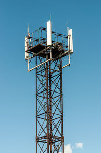 Low angle view of communications tower against sky