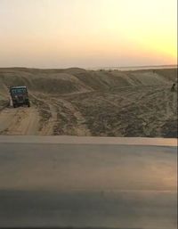 Car on road against sky during sunset