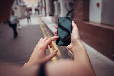 Midsection of woman using mobile phone