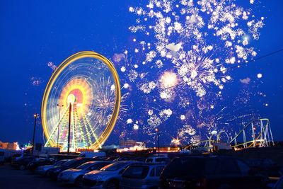 Low angle view of ferris wheel against sky at night