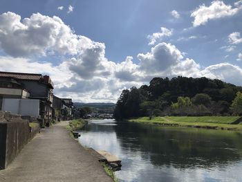 Panoramic view of buildings and trees against sky