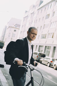 Man riding bicycle on city street