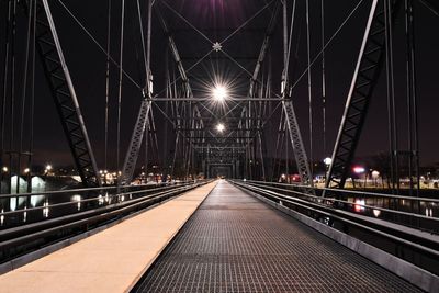 Illuminated bridge at night