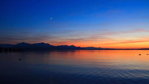 Scenic view of lake at sunset