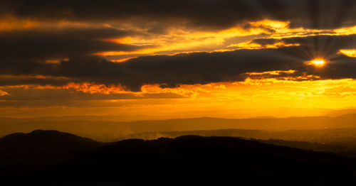 Scenic view of dramatic sky during sunset