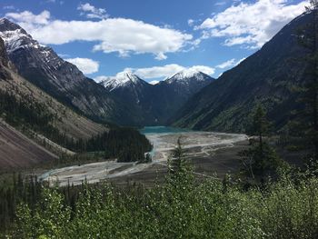 Scenic view of lake by mountains against sky