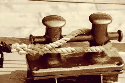 Close-up of rope tied on wood