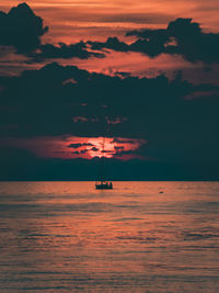 A vessel crossing the sun eyeball at the horizon