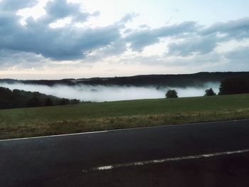 Scenic view of landscape against cloudy sky