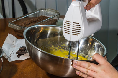 Midsection of person preparing food in kitchen