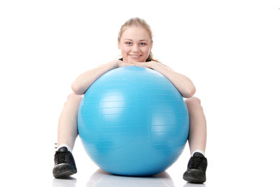 Portrait of a smiling young woman against white background