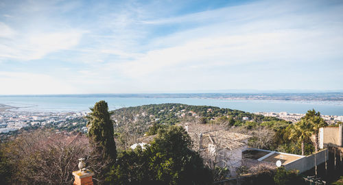 High angle view of townscape by sea against sky