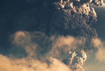 Low angle view of smoke emitting from volcanic against sky