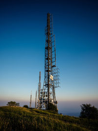 Low angle view of communications tower against sky