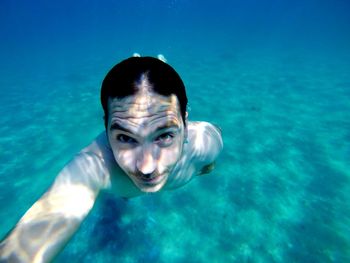 Portrait of man swimming in sea